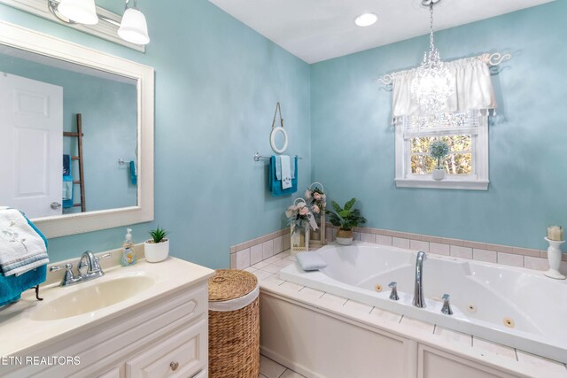 bathroom featuring a washtub, vanity, and tile patterned floors