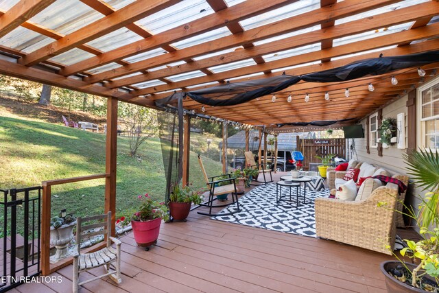 wooden deck featuring a yard and a pergola