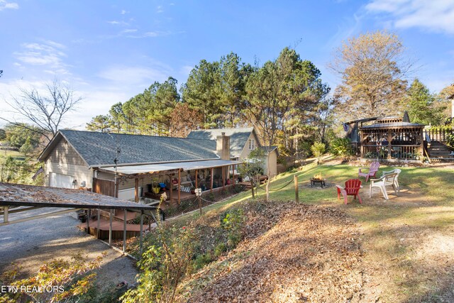 view of yard with an outdoor fire pit