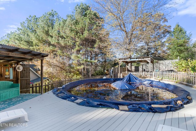 wooden terrace featuring a covered pool