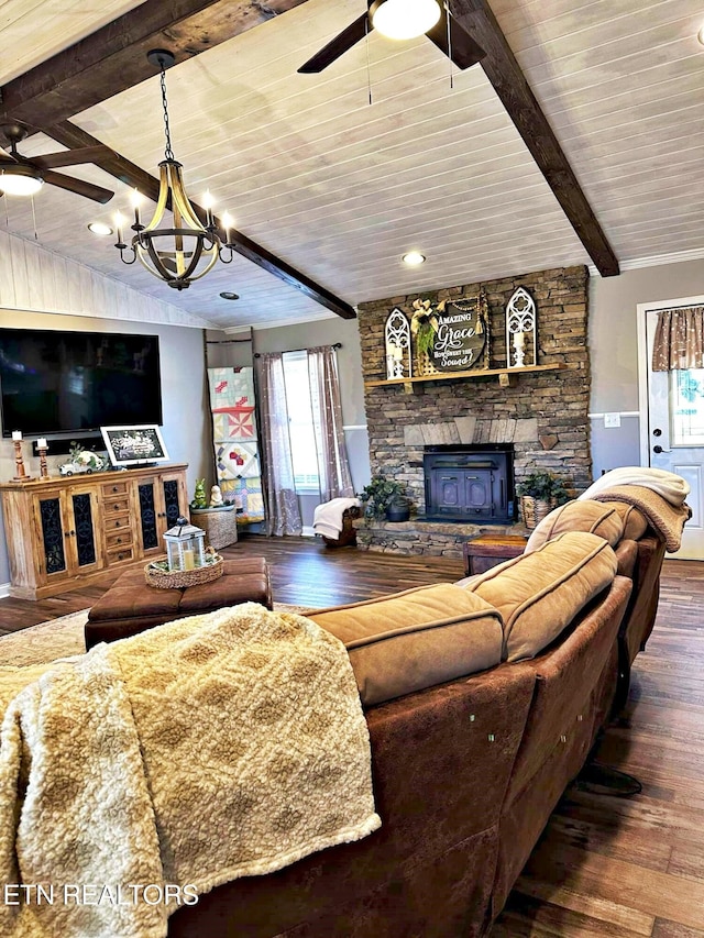 living room featuring wood-type flooring, a stone fireplace, ceiling fan with notable chandelier, and beam ceiling