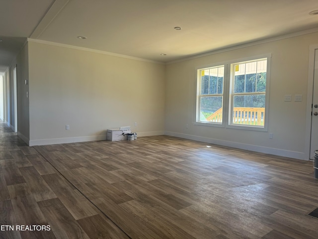 empty room featuring dark hardwood / wood-style floors and crown molding