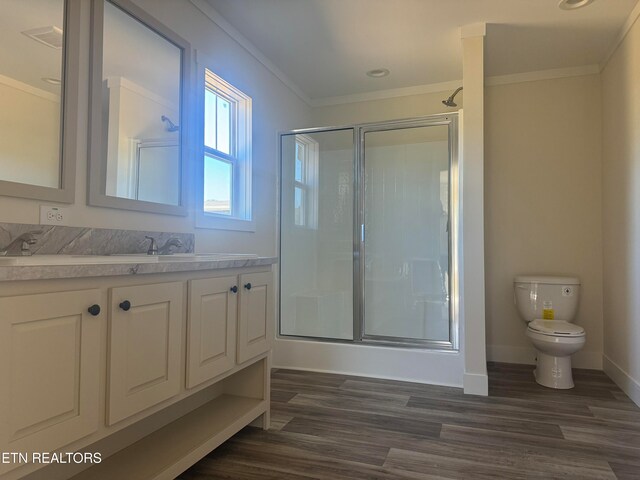 bathroom featuring hardwood / wood-style floors, crown molding, and walk in shower