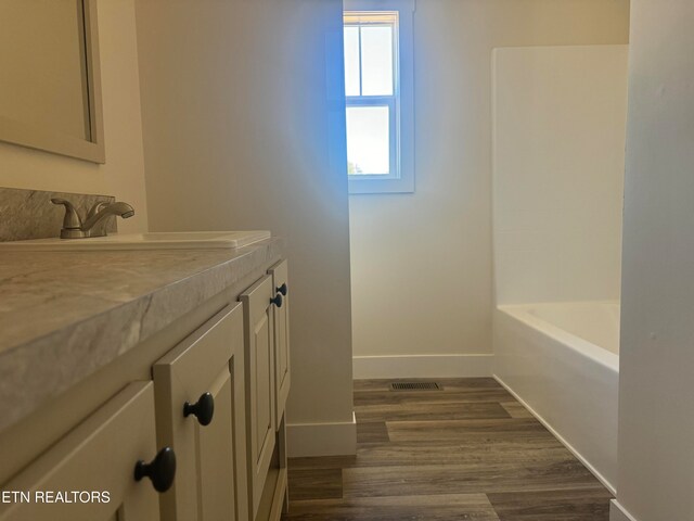 bathroom featuring hardwood / wood-style floors and vanity