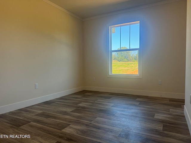 spare room with dark hardwood / wood-style floors and ornamental molding