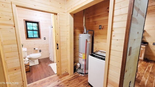 1312 Sweetwater Rd, Newport, TN 37821 - bathroom with water heater, washer / clothes dryer, wooden walls, toilet, and wood-type flooring