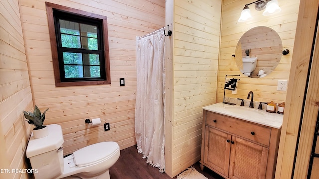 bathroom featuring walk in shower, wood-type flooring, toilet, wooden walls, and vanity