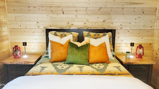 bedroom featuring wooden walls