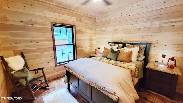 bedroom with wooden walls, hardwood / wood-style floors, ceiling fan, and wooden ceiling