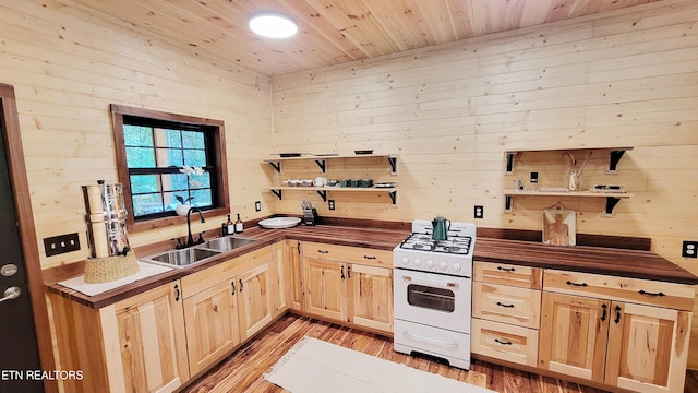 kitchen featuring wood ceiling, sink, light hardwood / wood-style flooring, white range with gas stovetop, and wood walls