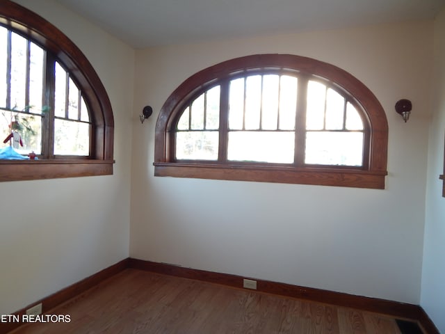 unfurnished room featuring hardwood / wood-style floors