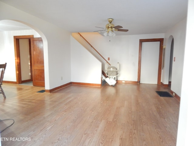 unfurnished living room featuring ceiling fan and light hardwood / wood-style floors