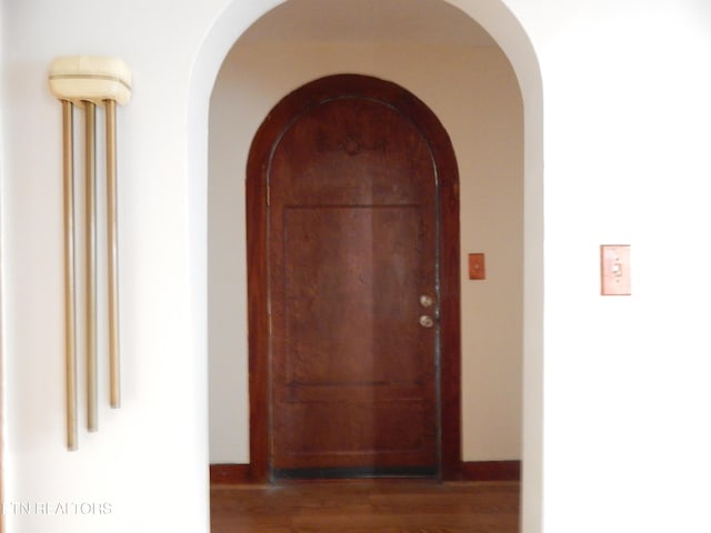 corridor featuring dark hardwood / wood-style floors