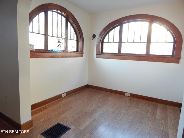 unfurnished room with light hardwood / wood-style floors