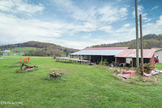 view of yard with an outbuilding and a rural view