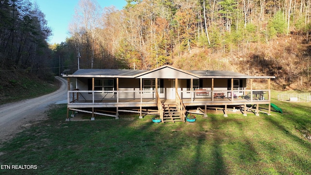 593 Cane Creek Mountain Rd, Tellico Plains, TN 37385 - view of front of house featuring a front yard, covered porch, and a view of trees