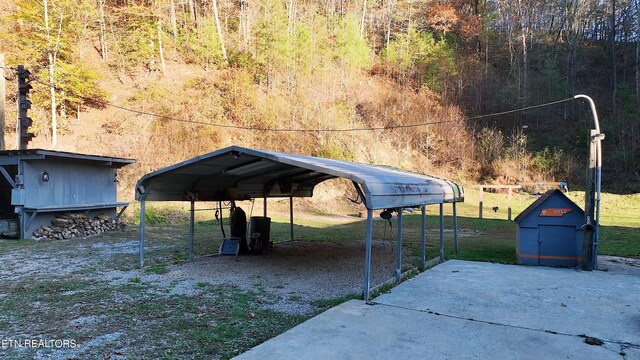 593 Cane Creek Mountain Rd, Tellico Plains, TN 37385 - view of parking with a carport and a forest view