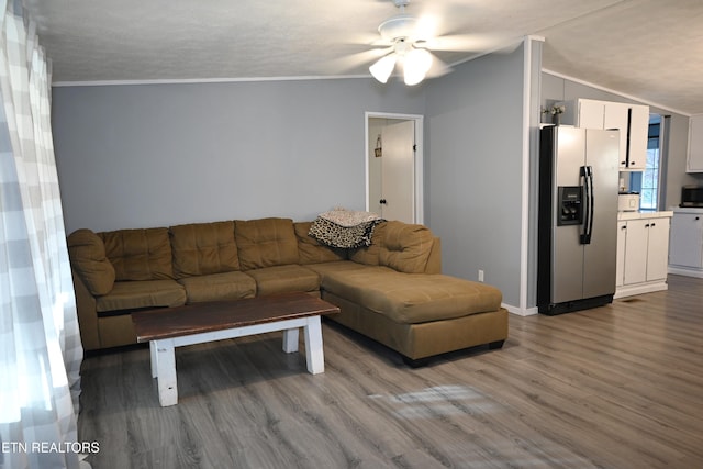 593 Cane Creek Mountain Rd, Tellico Plains, TN 37385 - living area with wood finished floors, ornamental molding, a ceiling fan, lofted ceiling, and baseboards