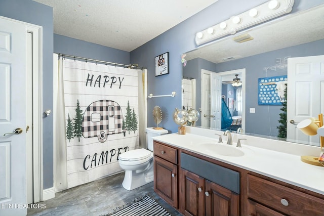 bathroom featuring vanity, a textured ceiling, toilet, and ceiling fan