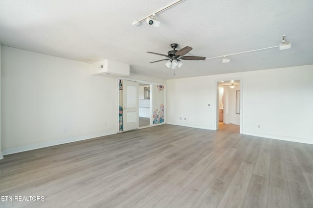 unfurnished room featuring ceiling fan, light hardwood / wood-style flooring, track lighting, and a textured ceiling