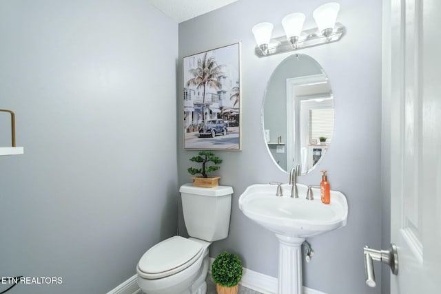 bathroom with a textured ceiling and toilet