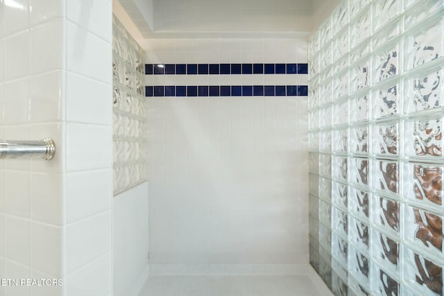 bathroom with tiled shower