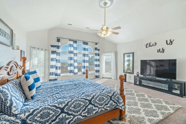 bedroom with a textured ceiling, ceiling fan, carpet floors, and lofted ceiling