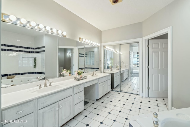 bathroom with a washtub and vanity