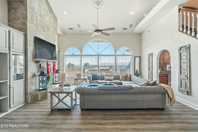 living room featuring ceiling fan and dark hardwood / wood-style flooring