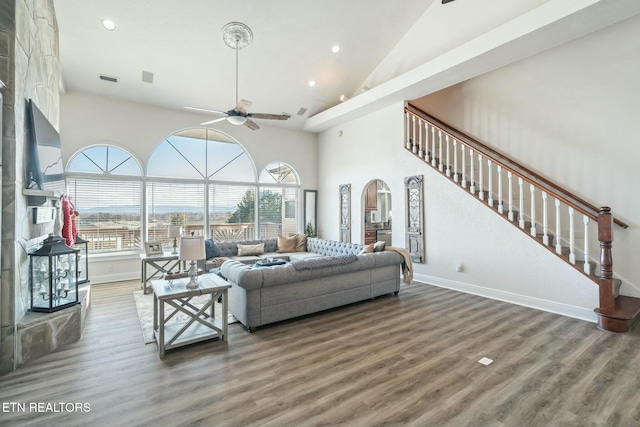 living room with dark hardwood / wood-style flooring, high vaulted ceiling, and ceiling fan