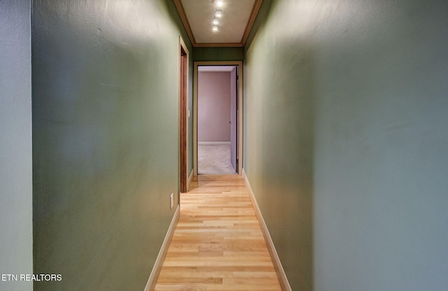 hall featuring crown molding and light hardwood / wood-style flooring