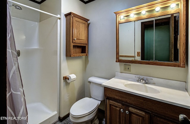 bathroom with vanity, toilet, and walk in shower