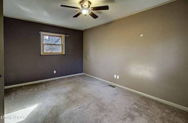 unfurnished room with ceiling fan, carpet floors, and a textured ceiling