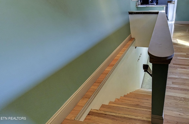 stairs featuring hardwood / wood-style flooring