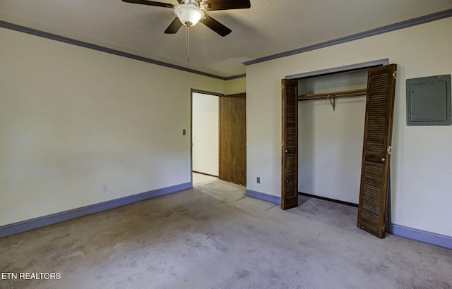 unfurnished bedroom featuring ceiling fan, light colored carpet, crown molding, and electric panel