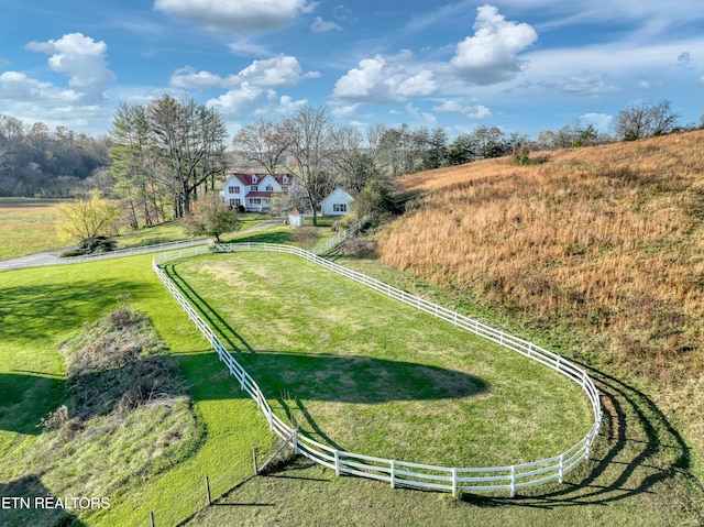 exterior space featuring a lawn and a rural view