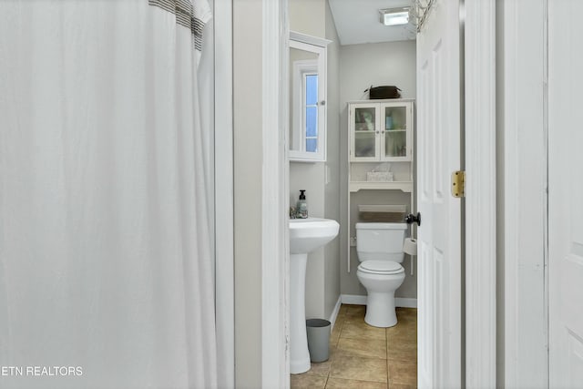 bathroom featuring tile patterned flooring and toilet