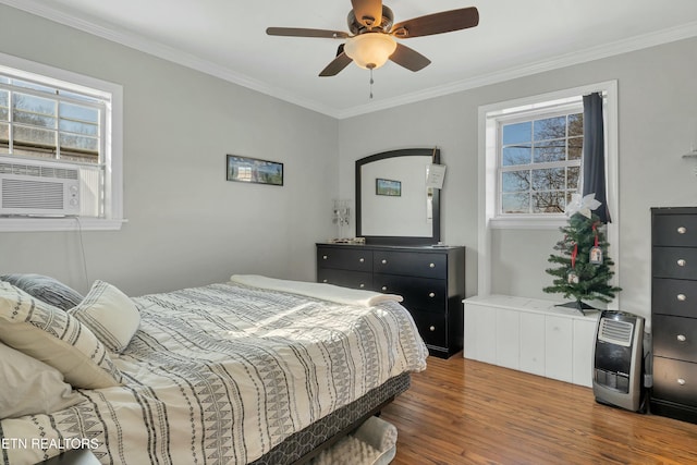 bedroom with ceiling fan, cooling unit, ornamental molding, and dark wood-type flooring