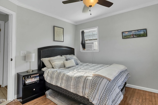 bedroom with ceiling fan, crown molding, and wood-type flooring