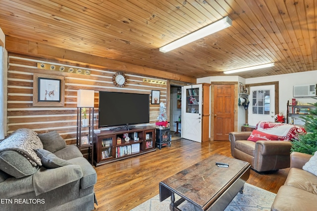 living room featuring an AC wall unit, wood walls, hardwood / wood-style floors, and wooden ceiling