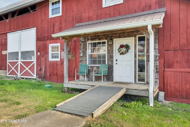 doorway to property featuring a lawn