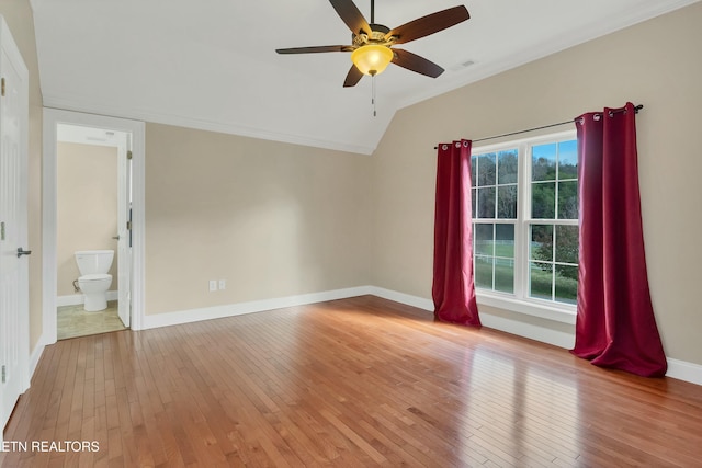 interior space with hardwood / wood-style flooring, ceiling fan, ornamental molding, and vaulted ceiling