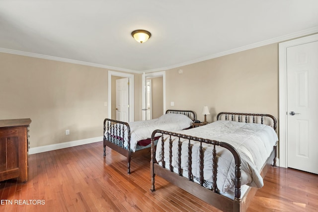 bedroom with hardwood / wood-style flooring and ornamental molding