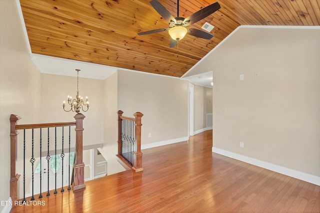 empty room featuring hardwood / wood-style floors, lofted ceiling, wooden ceiling, ceiling fan with notable chandelier, and ornamental molding