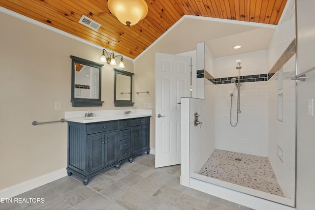 bathroom with vanity, vaulted ceiling, ornamental molding, tiled shower, and wood ceiling