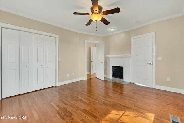 unfurnished living room with ceiling fan, hardwood / wood-style floors, and ornamental molding