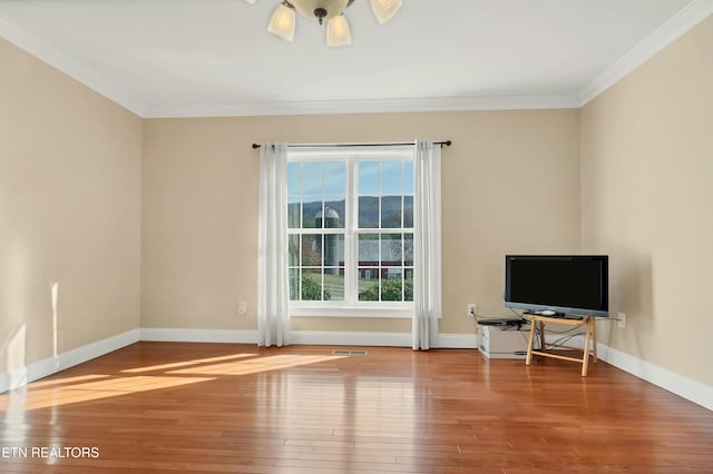 interior space featuring wood-type flooring and crown molding