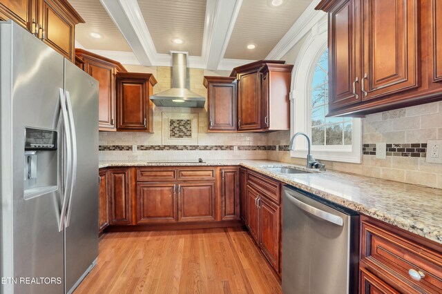 kitchen with ornamental molding, stainless steel appliances, sink, wall chimney range hood, and light hardwood / wood-style flooring