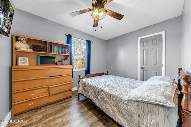 bedroom featuring ceiling fan and dark hardwood / wood-style floors