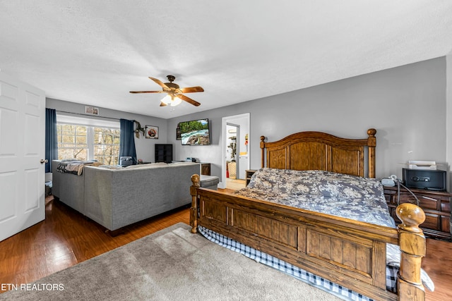 bedroom featuring a textured ceiling, dark hardwood / wood-style floors, and ceiling fan